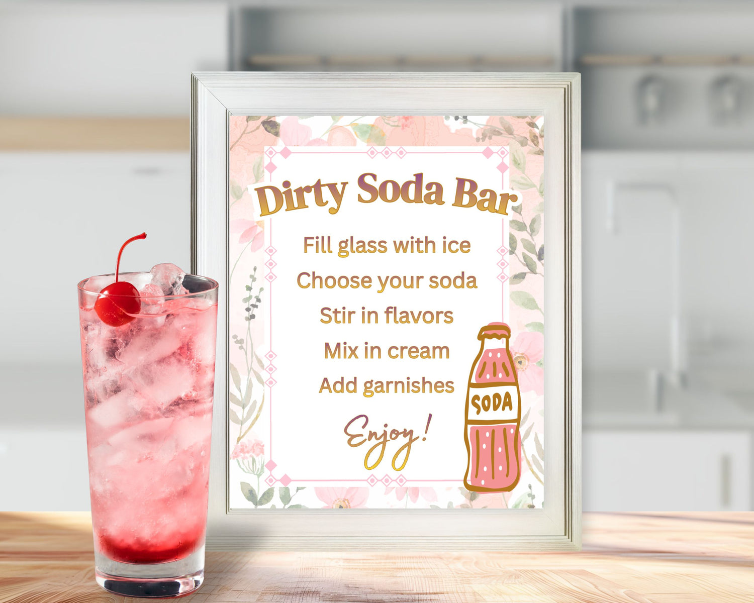 Decorative sign for a 'Dirty Soda Bar' with a pink drink and cherry on a wooden surface.